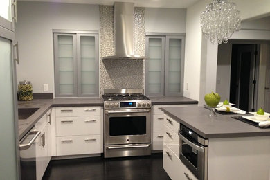 Kitchen pantry - mid-sized contemporary l-shaped dark wood floor and brown floor kitchen pantry idea in Los Angeles with an undermount sink, flat-panel cabinets, white cabinets, multicolored backsplash, glass tile backsplash, stainless steel appliances, an island and solid surface countertops