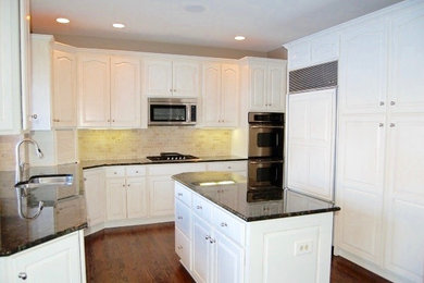 Inspiration for a contemporary kitchen in Chicago with shaker cabinets and white cabinets.