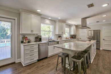 Country kitchen photo in Other with a farmhouse sink, shaker cabinets, yellow cabinets, ceramic backsplash, stainless steel appliances and an island
