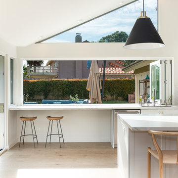 AG BiFold Patio Door & Window Pairing Connects All-White Kitchen to the Outdoors