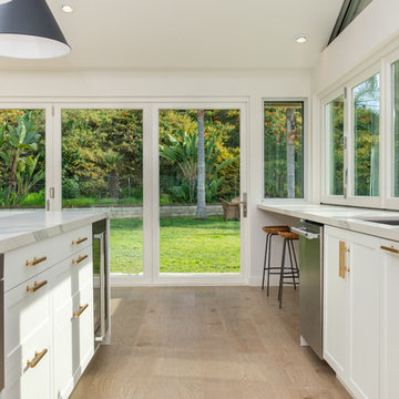 AG BiFold Patio Door & Window Pairing Connects All-White Kitchen to the Outdoors