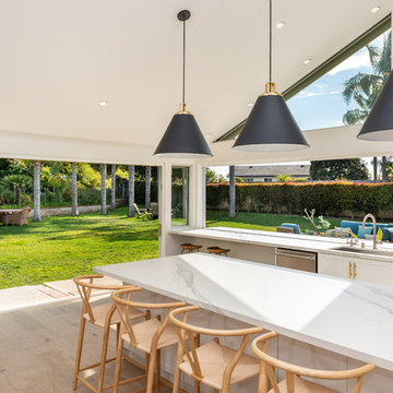 AG BiFold Patio Door & Window Pairing Connects All-White Kitchen to the Outdoors