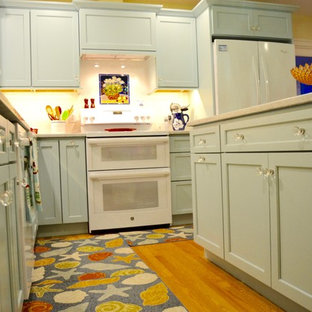 Esempio di una cucina stile marinaro di medie dimensioni con lavello stile country, ante lisce, ante turchesi, top in quarzo composito, paraspruzzi bianco, paraspruzzi con piastrelle diamantate, elettrodomestici bianchi, pavimento in legno massello medio e isola