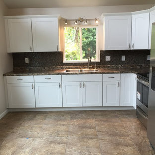 Photo of a small tropical u-shaped eat-in kitchen in Hawaii with a single-bowl sink, shaker cabinets, white cabinets, laminate benchtops, multi-coloured splashback, ceramic splashback, stainless steel appliances and ceramic floors.