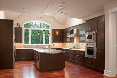 Large trendy u-shaped medium tone wood floor and brown floor eat-in kitchen photo in Chicago with dark wood cabinets, an island, an undermount sink, marble countertops, mosaic tile backsplash, stainless steel appliances, shaker cabinets and multicolored backsplash
