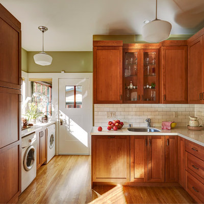 Enclosed kitchen - mid-sized craftsman l-shaped medium tone wood floor enclosed kitchen idea in San Francisco with an undermount sink, shaker cabinets, medium tone wood cabinets, quartz countertops, white backsplash, ceramic backsplash and white appliances