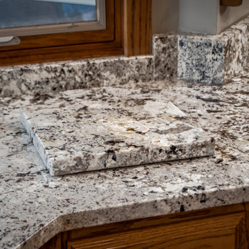 Alaska White Granite with Oak Cabinets Kitchen