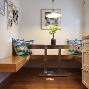 Design ideas for a small contemporary eat-in kitchen in San Francisco with recessed-panel cabinets, concrete benchtops, bamboo floors, brown floor and grey benchtop.