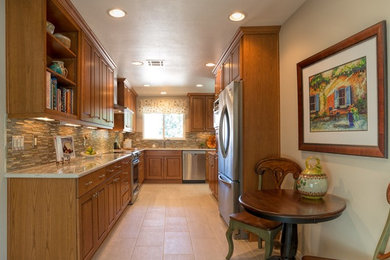 Mid-sized transitional u-shaped ceramic tile eat-in kitchen photo in Albuquerque with raised-panel cabinets, medium tone wood cabinets, granite countertops, multicolored backsplash, matchstick tile backsplash, stainless steel appliances, no island and an undermount sink