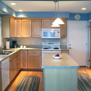 Inspiration for a traditional l-shaped eat-in kitchen in Detroit with a double-bowl sink, flat-panel cabinets, light wood cabinets, laminate benchtops, white splashback, porcelain splashback and white appliances.