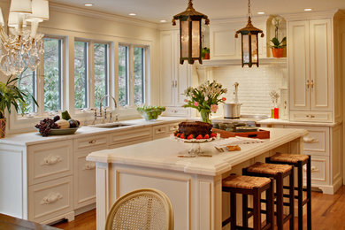 Example of a french country kitchen design in New York with recessed-panel cabinets, stainless steel appliances, subway tile backsplash, an undermount sink, white cabinets, marble countertops and white backsplash