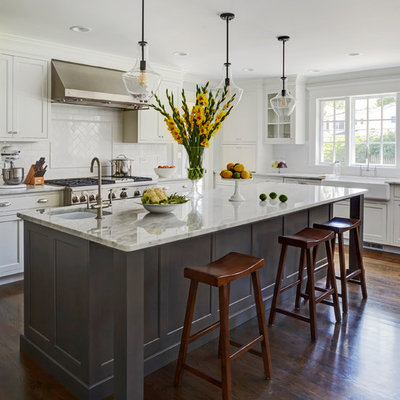 Inspiration for a large transitional dark wood floor kitchen remodel in Chicago with a single-bowl sink, recessed-panel cabinets, white cabinets, marble countertops, white backsplash, subway tile backsplash, stainless steel appliances and an island