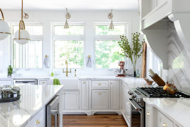 Large transitional kitchen photo in Other with white cabinets and an island