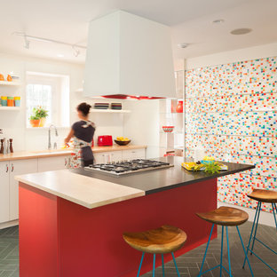 Mid-sized contemporary eat-in kitchen photos - Mid-sized trendy galley slate floor eat-in kitchen photo in Philadelphia with an undermount sink, flat-panel cabinets, white cabinets, wood countertops, an island and white backsplash