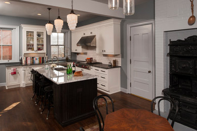 Eat-in kitchen - large modern u-shaped medium tone wood floor eat-in kitchen idea in New York with an undermount sink, recessed-panel cabinets, white cabinets, marble countertops, white backsplash, subway tile backsplash, stainless steel appliances and an island