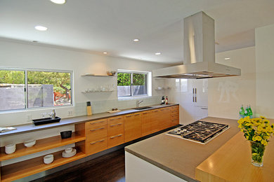 Modern kitchen in Los Angeles with a single-bowl sink, open cabinets and medium wood cabinets.
