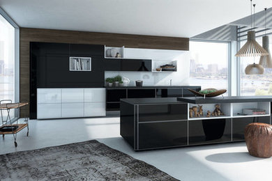 This is an example of a modern kitchen in Essex with black cabinets.