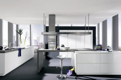 Inspiration for a medium sized contemporary single-wall open plan kitchen in New York with flat-panel cabinets, white cabinets, concrete worktops, stainless steel appliances, cement flooring, an island and grey floors.