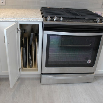 Alpha, IL White and Gray Kitchen with Hidden Laundry and Raised Dishwasher