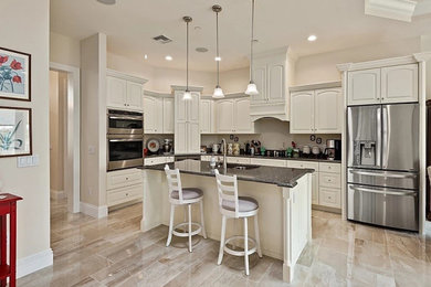 Design ideas for a medium sized traditional kitchen in Other with raised-panel cabinets, white cabinets and an island.