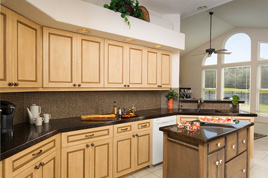 This is an example of a medium sized traditional u-shaped kitchen pantry in Jacksonville with a submerged sink, recessed-panel cabinets, beige cabinets, granite worktops, brown splashback, white appliances, ceramic flooring, an island, beige floors, mosaic tiled splashback, black worktops and a vaulted ceiling.