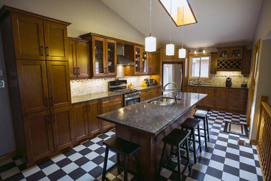 Inspiration for a kitchen remodel in Toronto with dark wood cabinets, quartz countertops and gray backsplash
