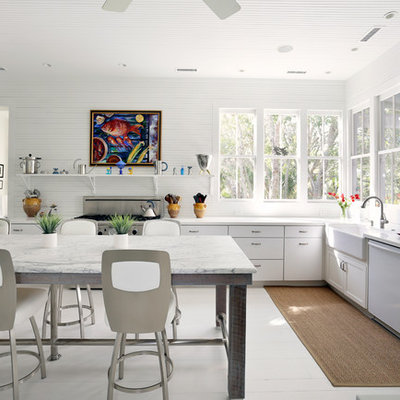 Eat-in kitchen - traditional l-shaped white floor eat-in kitchen idea in San Francisco with a farmhouse sink, flat-panel cabinets, white cabinets and stainless steel appliances