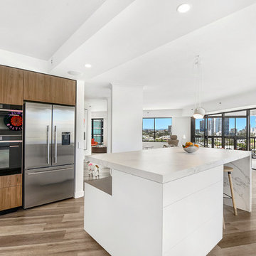 An entertainer's kitchen with two ovens and a workbench for more than one cook