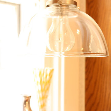 An industrial glass pendant provides light without blocking natural light.