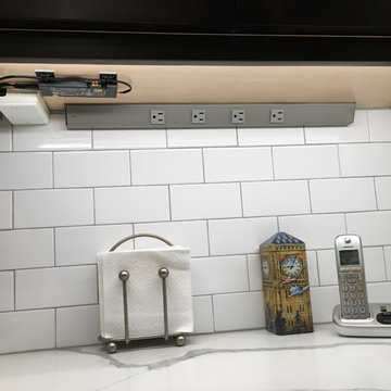 Angled Power Strips Concealed Below Upper Cabinets Keep the Backsplashes Clear