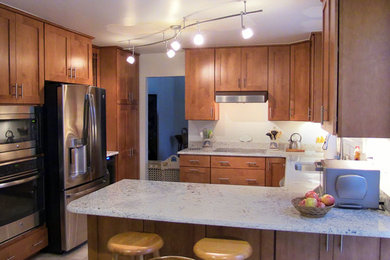 Example of a small classic u-shaped ceramic tile eat-in kitchen design in Baltimore with a double-bowl sink, shaker cabinets, medium tone wood cabinets, granite countertops, white backsplash, stainless steel appliances and no island