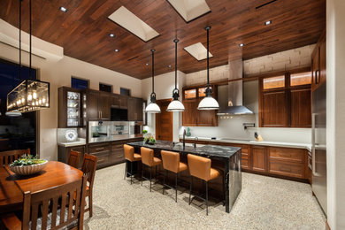 Example of a large arts and crafts u-shaped terrazzo floor and multicolored floor open concept kitchen design in Las Vegas with a farmhouse sink, shaker cabinets, dark wood cabinets, marble countertops, gray backsplash, quartz backsplash, stainless steel appliances, an island and multicolored countertops