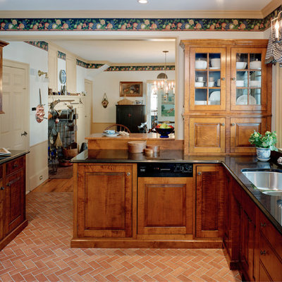 Eat-in kitchen - mid-sized traditional terra-cotta tile eat-in kitchen idea in Boston with a double-bowl sink, raised-panel cabinets, medium tone wood cabinets, granite countertops and stainless steel appliances