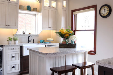 Mid-sized country u-shaped ceramic tile and brown floor enclosed kitchen photo in Toronto with a farmhouse sink, shaker cabinets, white cabinets, quartzite countertops, gray backsplash, stainless steel appliances and an island