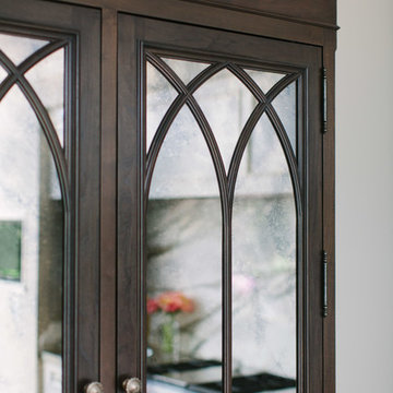 Antique mirror glass and gothic arched mullions on food pantry