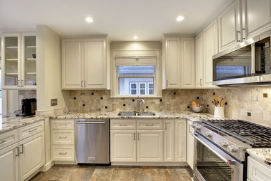 Example of a mid-sized transitional l-shaped slate floor and beige floor eat-in kitchen design in Other with an undermount sink, shaker cabinets, white cabinets, granite countertops, beige backsplash, travertine backsplash, stainless steel appliances and no island