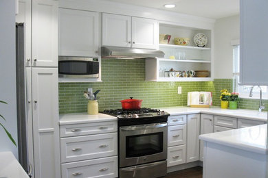 Small transitional u-shaped dark wood floor kitchen photo in San Diego with an undermount sink, beaded inset cabinets, white cabinets, solid surface countertops, green backsplash, ceramic backsplash, stainless steel appliances and no island