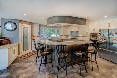 Example of a mid-sized transitional u-shaped multicolored floor eat-in kitchen design in Other with an undermount sink, shaker cabinets, medium tone wood cabinets, quartz countertops, white backsplash, subway tile backsplash, stainless steel appliances and an island