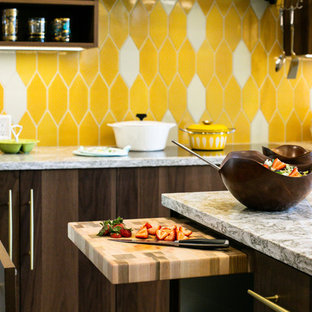 This is an example of a mid-sized midcentury l-shaped eat-in kitchen in Denver with an undermount sink, flat-panel cabinets, medium wood cabinets, quartz benchtops, yellow splashback, ceramic splashback, stainless steel appliances, light hardwood floors, with island, brown floor and multi-coloured benchtop.