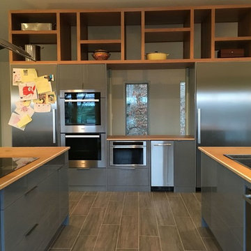 Appliance wall and custom cherry open shelving.