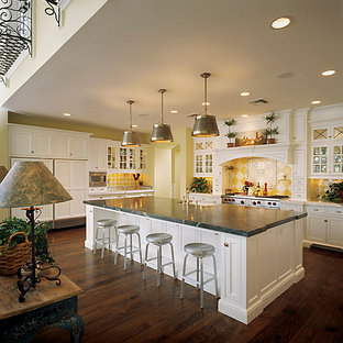 Large traditional open concept kitchen ideas - Open concept kitchen - large traditional u-shaped medium tone wood floor open concept kitchen idea in Phoenix with recessed-panel cabinets, white cabinets, marble countertops, yellow backsplash, ceramic backsplash, stainless steel appliances and an island
