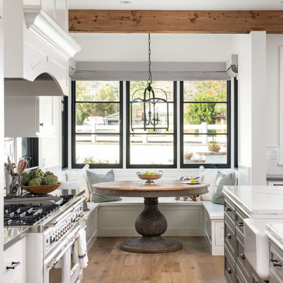Cottage galley medium tone wood floor and brown floor eat-in kitchen photo in Phoenix with a farmhouse sink, gray cabinets and white countertops