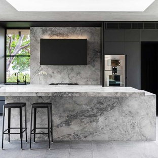 Inspiration for a large contemporary galley kitchen in Sydney with an undermount sink, black cabinets, marble benchtops, grey splashback, marble splashback, stainless steel appliances, with island, grey floor, grey benchtop and flat-panel cabinets.