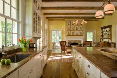 Eat-in kitchen - mid-sized country galley medium tone wood floor and brown floor eat-in kitchen idea in Raleigh with an undermount sink, recessed-panel cabinets, white cabinets, marble countertops, an island, yellow backsplash and stainless steel appliances