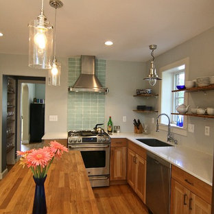 Design ideas for a mid-sized contemporary l-shaped eat-in kitchen in DC Metro with an undermount sink, recessed-panel cabinets, medium wood cabinets, recycled glass benchtops, green splashback, glass tile splashback, stainless steel appliances, medium hardwood floors and with island.