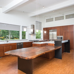 Photo of a large asian l-shaped eat-in kitchen in Detroit with a double-bowl sink, flat-panel cabinets, medium wood cabinets, quartzite benchtops, white splashback, stone slab splashback, stainless steel appliances, cork floors and with island.