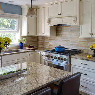Mid-sized transitional eat-in kitchen photos - Eat-in kitchen - mid-sized transitional u-shaped medium tone wood floor and brown floor eat-in kitchen idea in Chicago with a single-bowl sink, recessed-panel cabinets, white cabinets, granite countertops, beige backsplash, stone tile backsplash, stainless steel appliances and an island