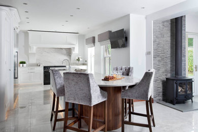 Inspiration for a medium sized traditional l-shaped open plan kitchen in Other with an integrated sink, shaker cabinets, blue cabinets, marble worktops, grey splashback, marble splashback, stainless steel appliances, porcelain flooring, an island and grey floors.