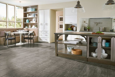 Example of a large trendy single-wall porcelain tile eat-in kitchen design in Other with recessed-panel cabinets, white cabinets, gray backsplash, matchstick tile backsplash and an island