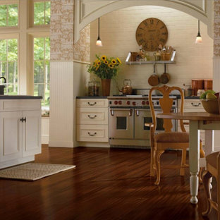 Large farmhouse eat-in kitchen designs - Inspiration for a large farmhouse l-shaped dark wood floor eat-in kitchen remodel in Philadelphia with recessed-panel cabinets, white cabinets, white backsplash, brick backsplash, stainless steel appliances and an island